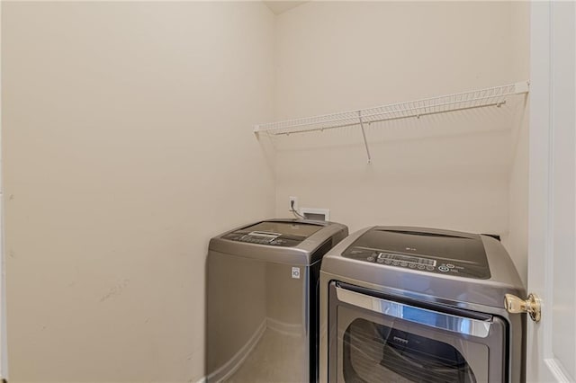 washroom featuring laundry area and separate washer and dryer