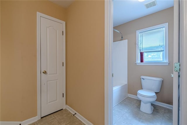 bathroom with visible vents, toilet, tub / shower combination, tile patterned flooring, and baseboards