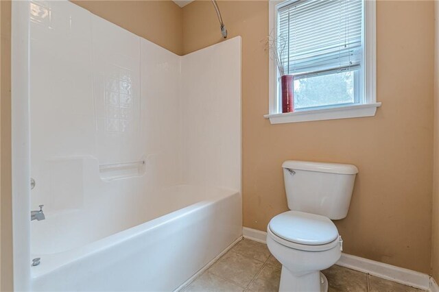 bathroom with toilet and bathtub / shower combination