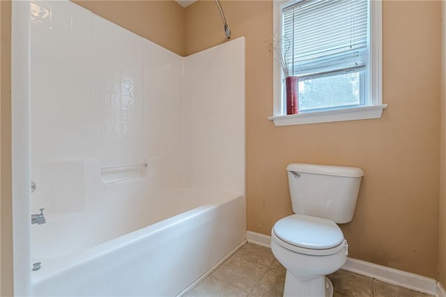 full bath featuring toilet, tile patterned flooring, baseboards, and tub / shower combination