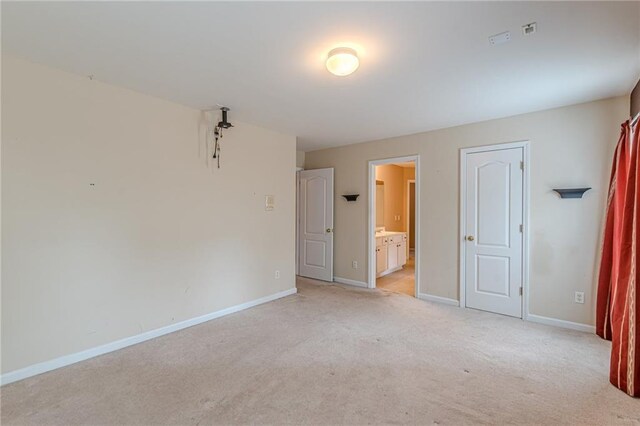 unfurnished bedroom with light carpet