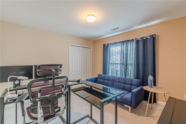 home office featuring carpet floors, visible vents, and baseboards