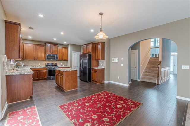 kitchen with sink, dishwasher, light stone counters, tasteful backsplash, and dark hardwood / wood-style floors