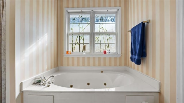 full bath with a jetted tub and wallpapered walls