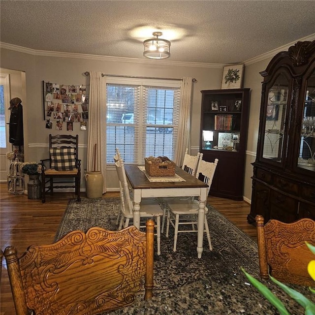 dining area featuring ornamental molding, dark hardwood / wood-style flooring, and a textured ceiling