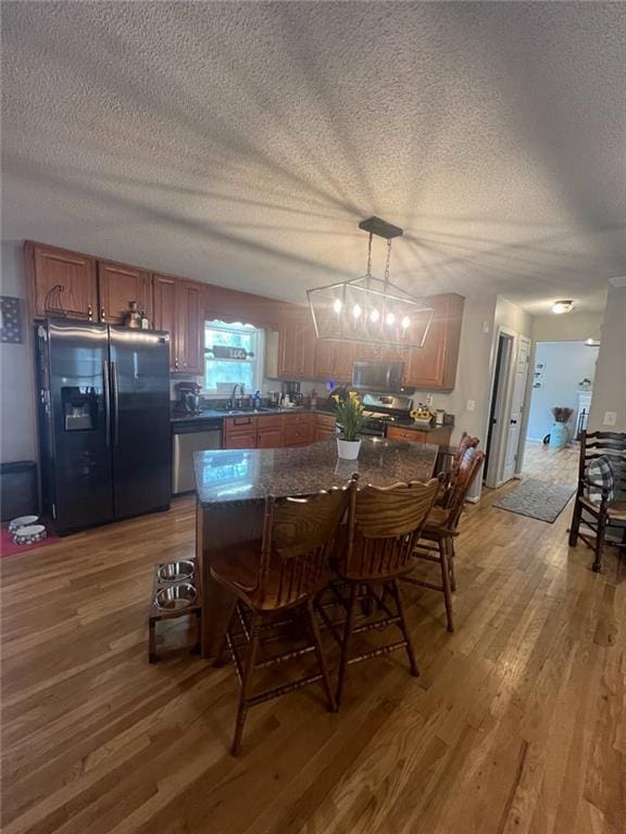 dining room with hardwood / wood-style flooring, sink, and a textured ceiling