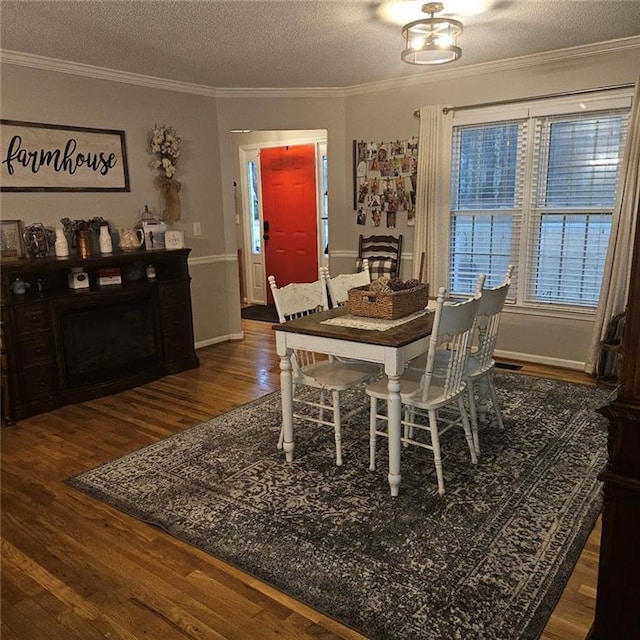 dining room with crown molding, dark hardwood / wood-style flooring, and a textured ceiling