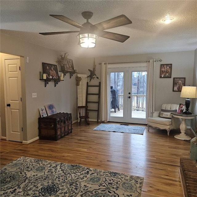 interior space with ceiling fan, hardwood / wood-style floors, a textured ceiling, and french doors