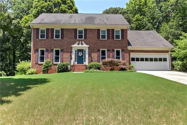 4875 Rivercliff Trce SW, Lilburn, GA 30047 - colonial home featuring a front lawn, a garage, concrete driveway, and brick siding
