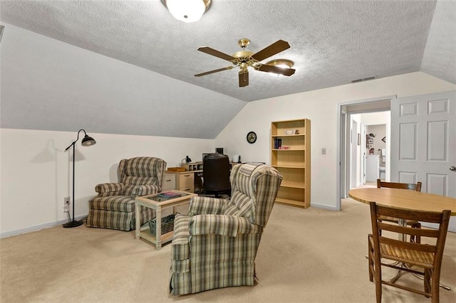 4875 Rivercliff Trce SW, Lilburn, GA 30047 - living area featuring light colored carpet, a ceiling fan, vaulted ceiling, a textured ceiling, and an office area