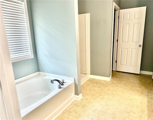 10175 Hemlock Way, Jonesboro, GA 30238 - bathroom with a garden tub, baseboards, and tile patterned floors