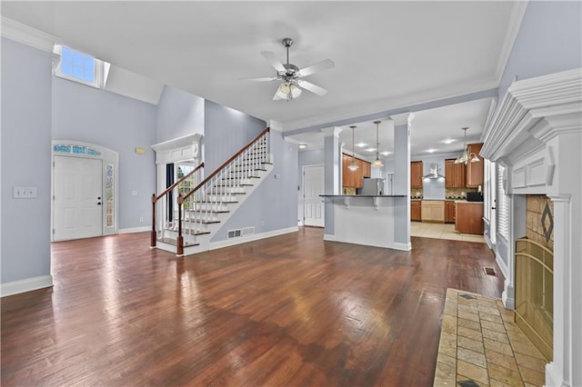 1920 Lee Patrick Dr, Dacula, GA 30019 - unfurnished living room featuring a fireplace, stairway, wood finished floors, baseboards, and ornamental molding