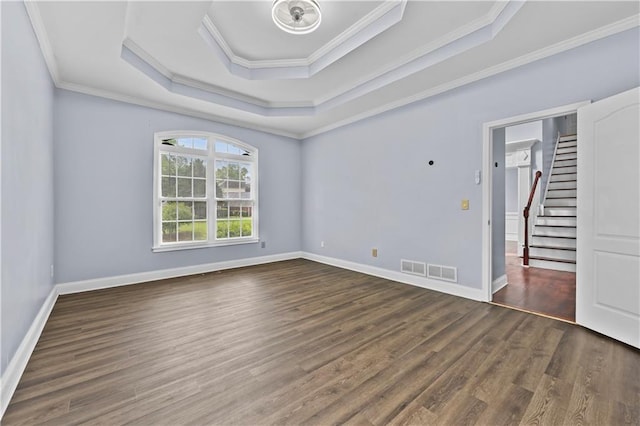 1920 Lee Patrick Dr, Dacula, GA 30019 - empty room featuring a tray ceiling, ornamental molding, wood finished floors, stairs, and baseboards