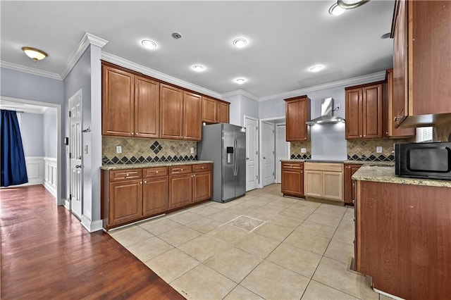 1920 Lee Patrick Dr, Dacula, GA 30019 - kitchen with stainless steel refrigerator with ice dispenser, black microwave, crown molding, wall chimney exhaust hood, and tasteful backsplash