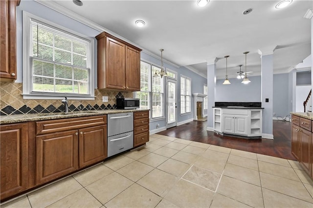 1920 Lee Patrick Dr, Dacula, GA 30019 - kitchen featuring stainless steel appliances, a sink, ceiling fan, healthy amount of natural light, and ornamental molding
