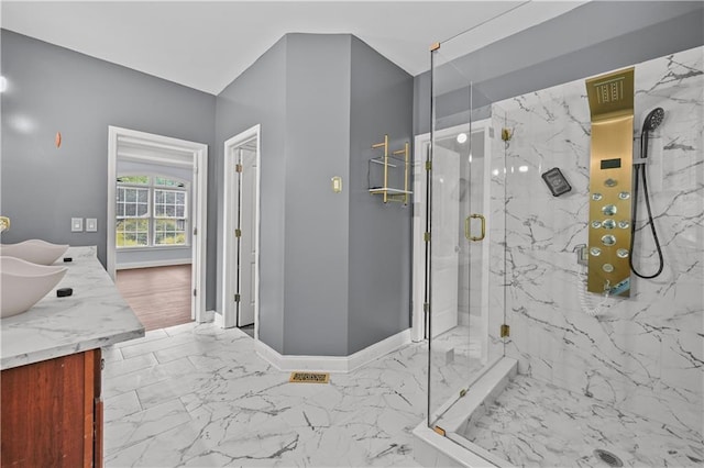 1920 Lee Patrick Dr, Dacula, GA 30019 - bathroom featuring marble finish flooring, a marble finish shower, double vanity, and baseboards