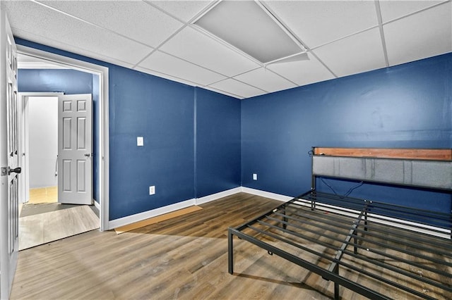 1920 Lee Patrick Dr, Dacula, GA 30019 - unfurnished bedroom featuring wood finished floors, baseboards, and a drop ceiling