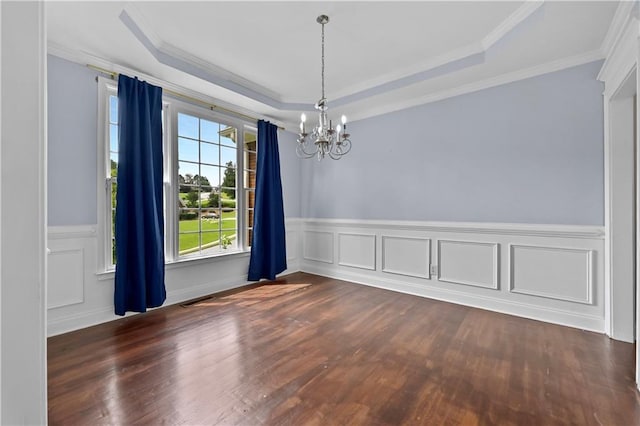 1920 Lee Patrick Dr, Dacula, GA 30019 - empty room with a chandelier, a raised ceiling, dark wood-type flooring, wainscoting, and ornamental molding