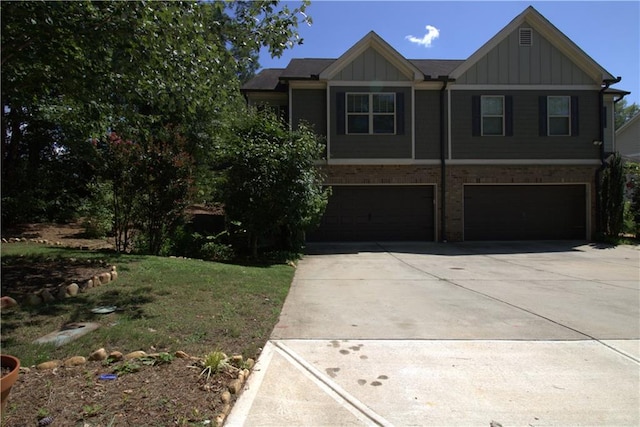 4746 Highland Ave, Sugar Hill, GA 30518 - view of front of property featuring board and batten siding, driveway, a garage, and brick siding