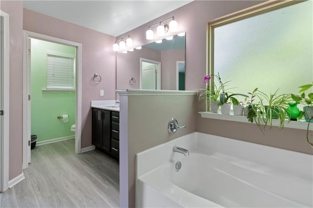 4746 Highland Ave, Sugar Hill, GA 30518 - bathroom with vanity, a bath, and wood finished floors