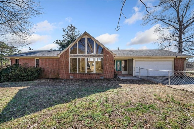 view of front of house with a garage and a front lawn