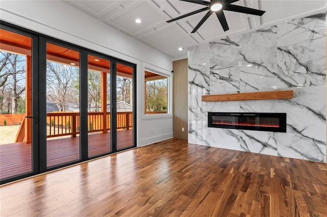 unfurnished living room with a fireplace, wood finished floors, recessed lighting, a ceiling fan, and coffered ceiling