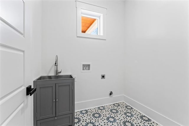 laundry area with baseboards, a sink, cabinet space, electric dryer hookup, and washer hookup