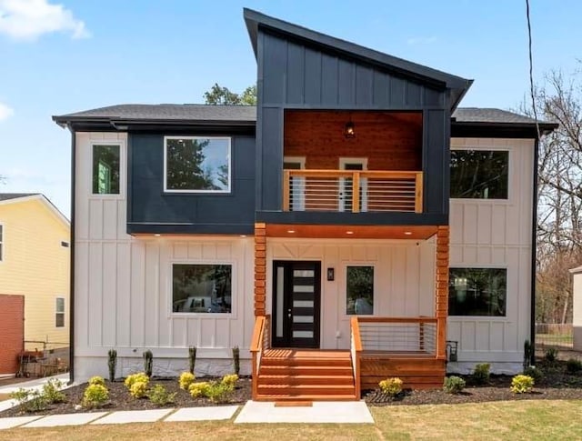 modern home featuring board and batten siding, a balcony, and a porch