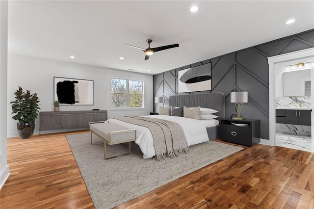 bedroom featuring recessed lighting, ensuite bath, ceiling fan, and wood finished floors