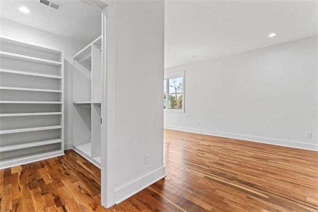 walk in closet with visible vents and wood finished floors