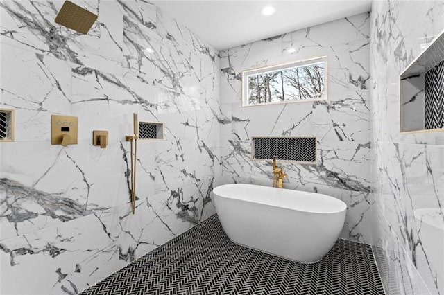 full bathroom featuring stone wall, a marble finish shower, recessed lighting, and a freestanding bath
