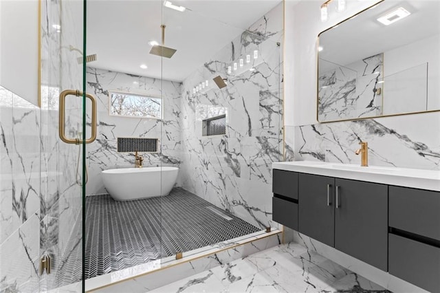 bathroom featuring marble finish floor, vanity, a marble finish shower, and tile walls