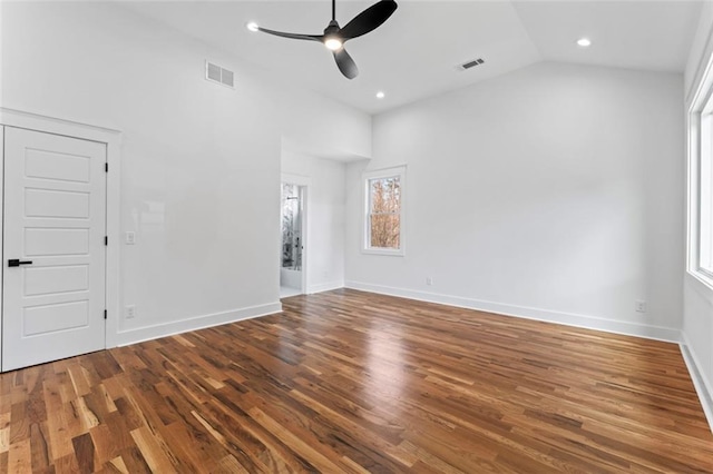 unfurnished room with vaulted ceiling, baseboards, visible vents, a ceiling fan, and wood finished floors