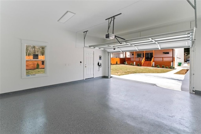 garage with baseboards and a garage door opener