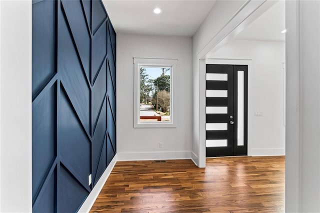 foyer with dark wood-style flooring, baseboards, and recessed lighting