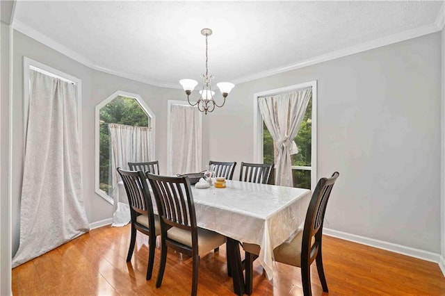 592 Ferry Creek Ct, Acworth, GA 30102 - dining room with light wood finished floors, a chandelier, and crown molding