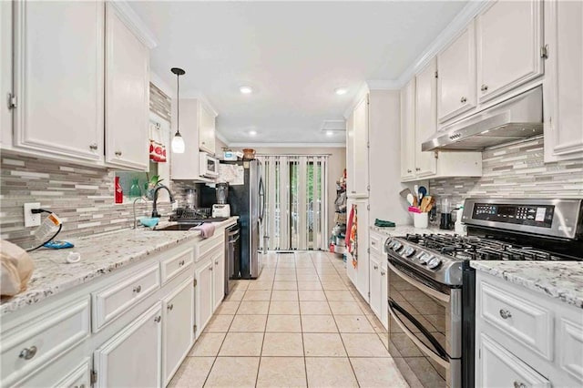 592 Ferry Creek Ct, Acworth, GA 30102 - kitchen with stainless steel appliances, under cabinet range hood, light tile patterned flooring, white cabinets, and tasteful backsplash