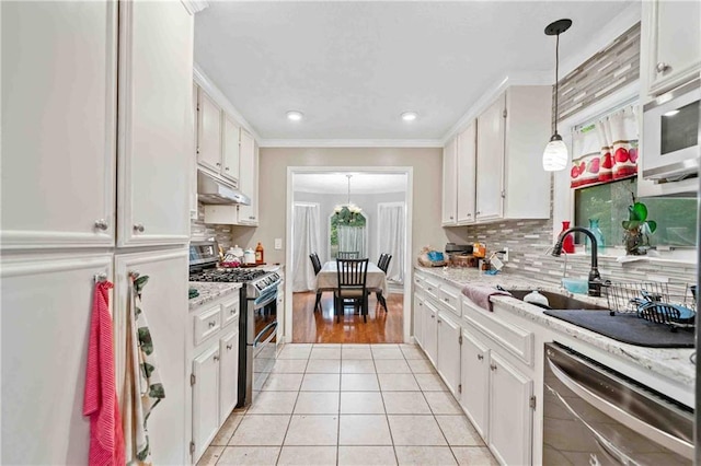 592 Ferry Creek Ct, Acworth, GA 30102 - kitchen featuring appliances with stainless steel finishes, under cabinet range hood, white cabinets, crown molding, and light tile patterned floors