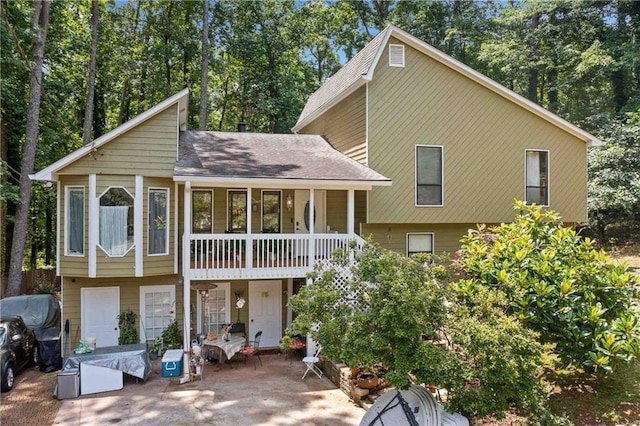 592 Ferry Creek Ct, Acworth, GA 30102 - view of front of house with a shingled roof and view of wooded area