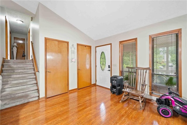 592 Ferry Creek Ct, Acworth, GA 30102 - foyer with wood finished floors, vaulted ceiling, and stairway