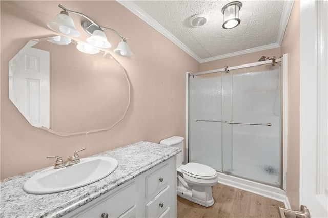 bathroom featuring a textured ceiling, hardwood / wood-style flooring, walk in shower, and crown molding