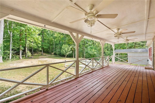 wooden terrace with a storage unit and ceiling fan