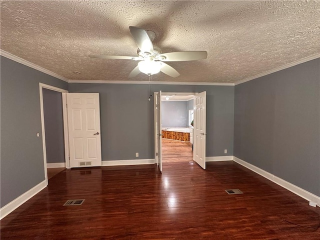 empty room with ornamental molding, a textured ceiling, ceiling fan, and dark wood-type flooring