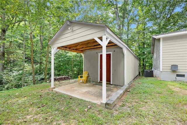 view of outdoor structure with a yard and central AC