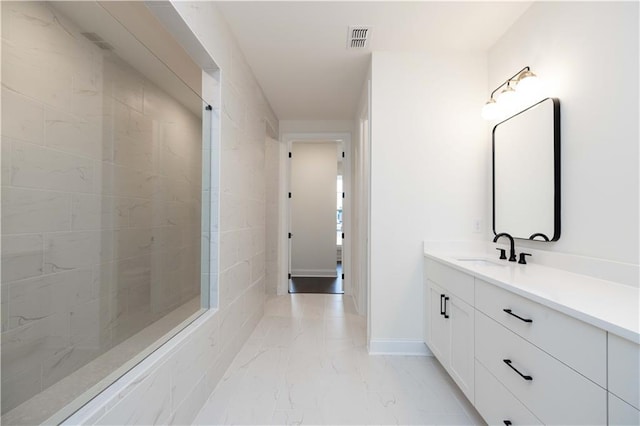 bathroom featuring vanity and tiled shower