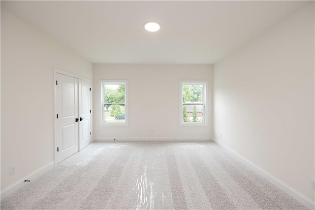 unfurnished room with light carpet