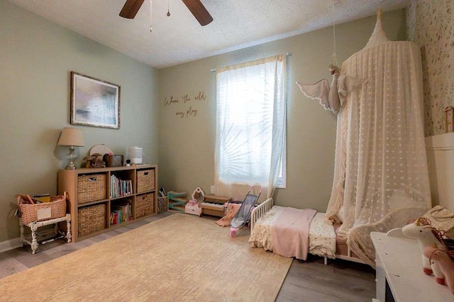 playroom with ceiling fan and hardwood / wood-style floors