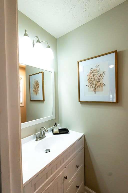 bathroom featuring vanity and a textured ceiling