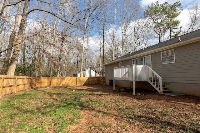 view of yard with a wooden deck and central AC