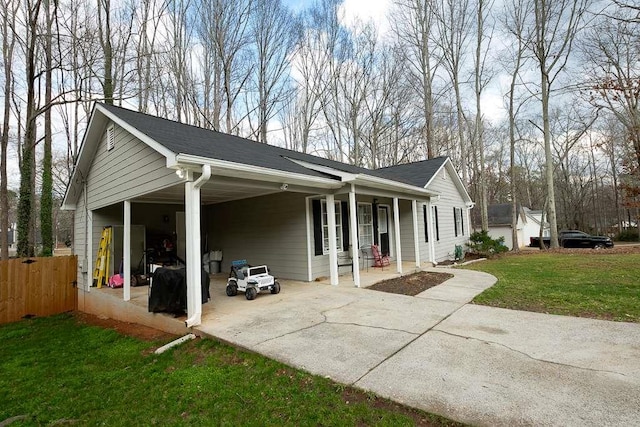 view of property exterior with a carport and a lawn